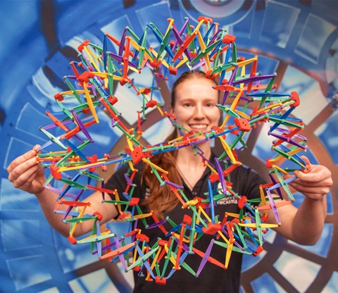 Person holding a Hoberman-Sphere