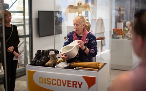 A female volunteer presents a talk at Sugar Valley Library Museum. 