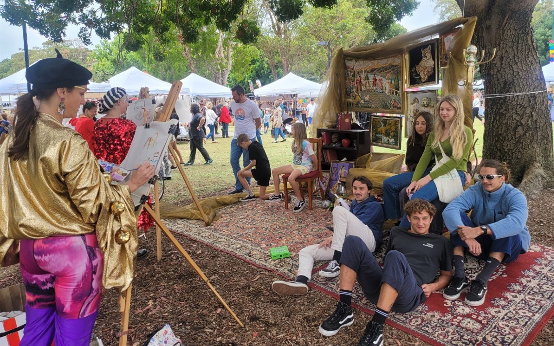 Female artist painting portrait of a group of people